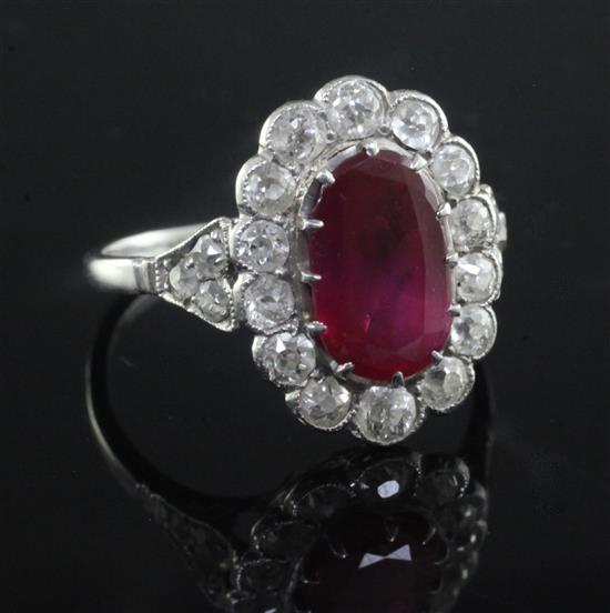 A mid 20th century, platinum, ruby and diamond oval cluster ring, size L.